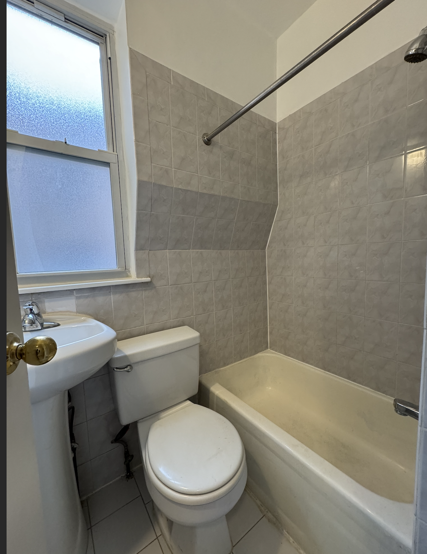 451 West 44th Street, Unit 63 Manhattan, NY 10036 - Photo 16 of 33 a white toilet sitting next to a bath tub and a shower