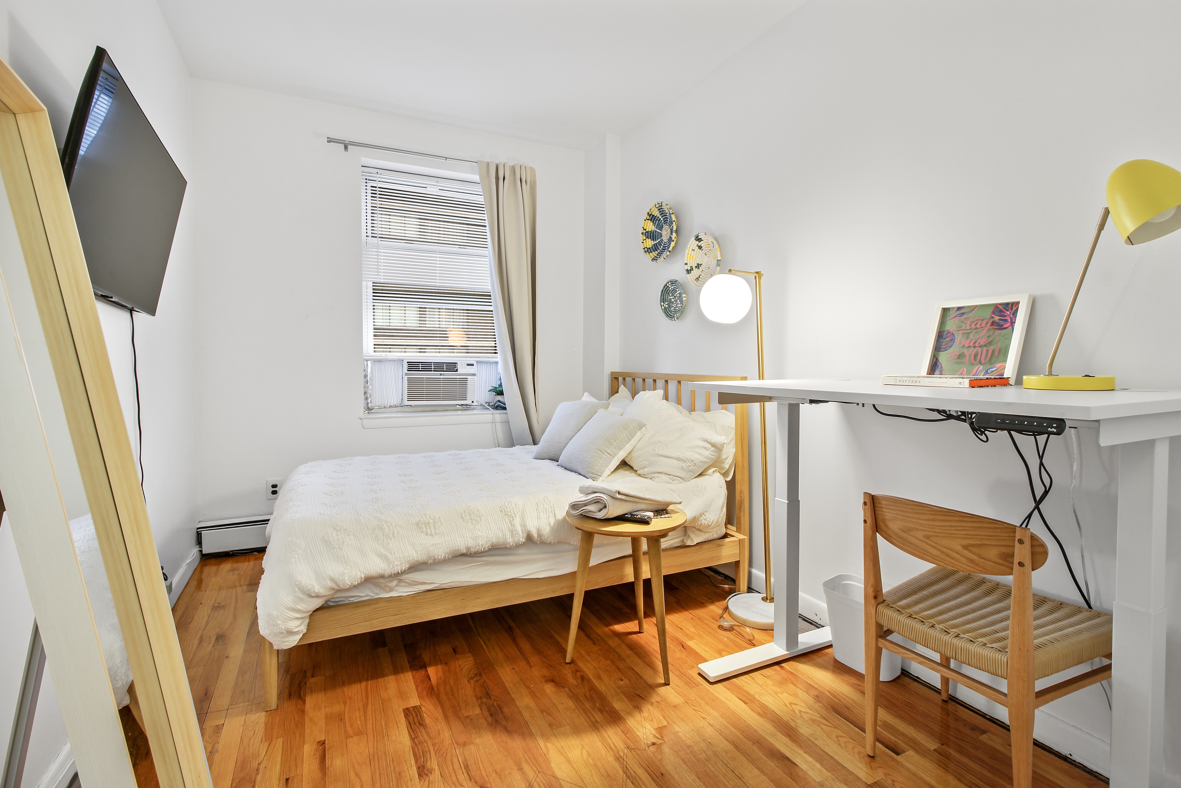 621 2nd Avenue, Unit 2 Manhattan, NY 10016 - Photo 3 of 8 a bedroom with a bed and wooden floor