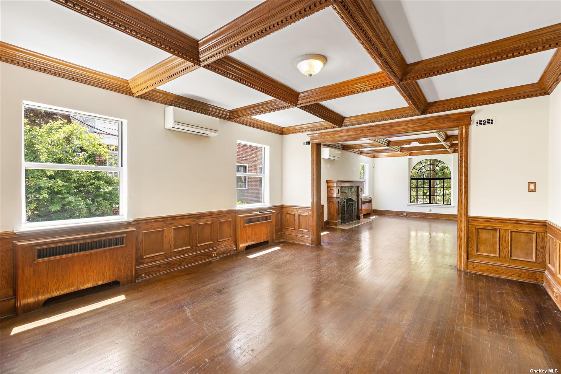 85-23 Edgerton Boulevard Queens, NY 11432 - Photo 7 of 36 a view of an empty room with wooden floor and a window