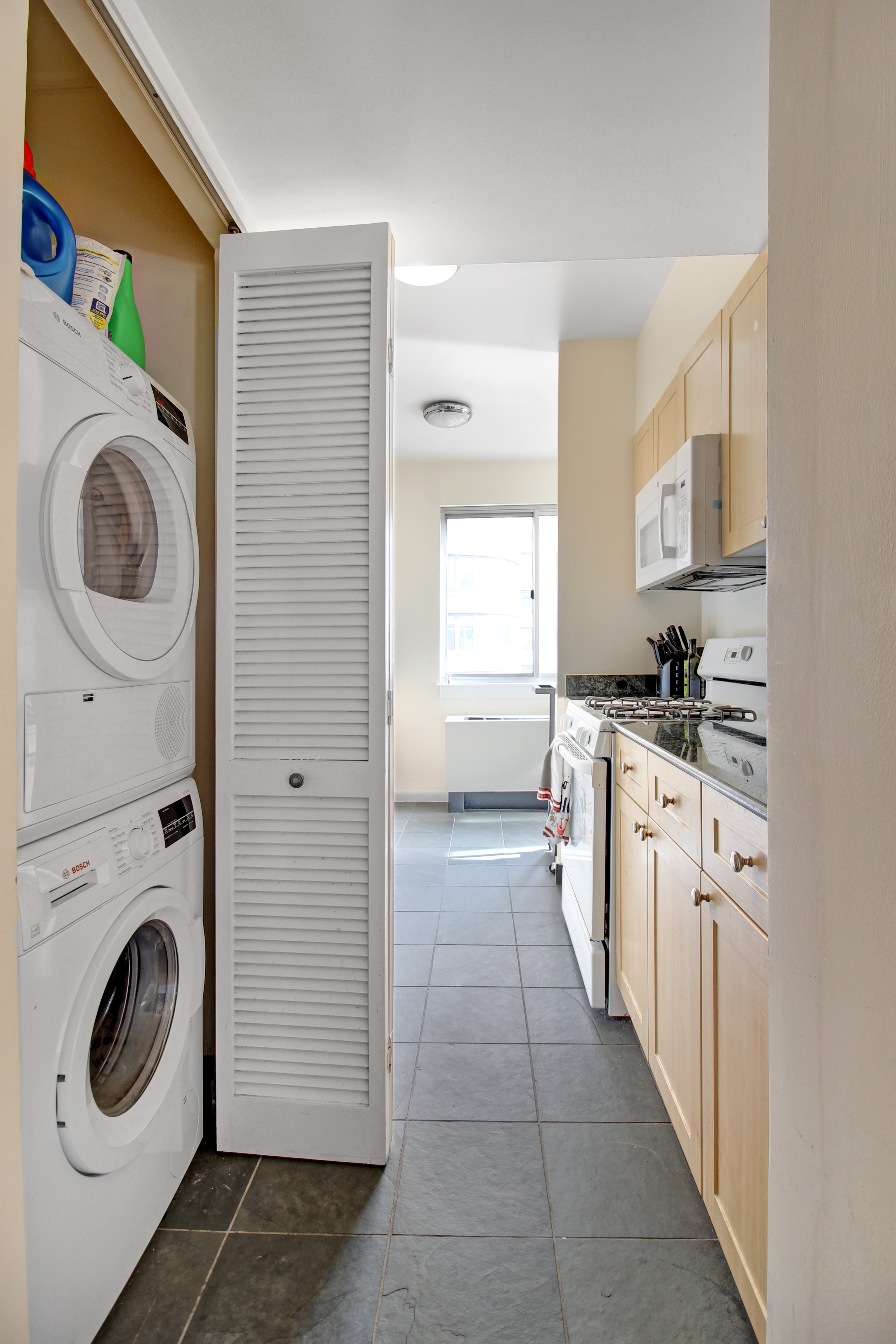 308 East 38th Street, Unit 20A Manhattan, NY 10016 - Photo 4 of 13 a kitchen with granite countertop a sink and a stove top oven