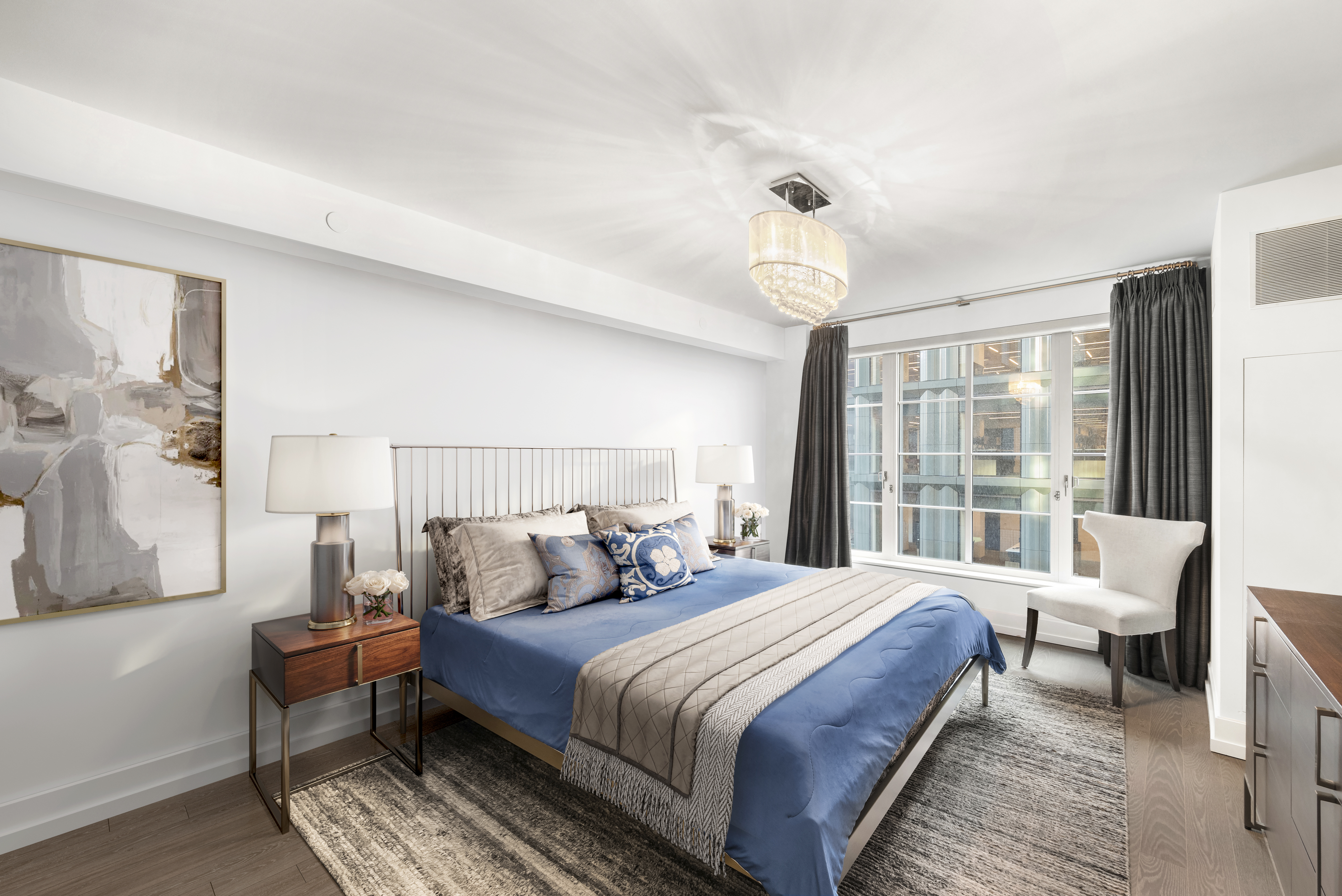 70 Charlton Street, Unit 11A Manhattan, NY 10014 - Photo 10 of 22 a bedroom with a bed and a chandelier