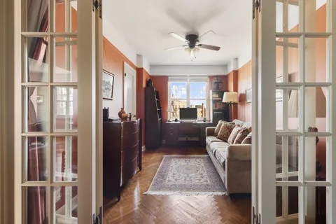 a living room with furniture and a chandelier