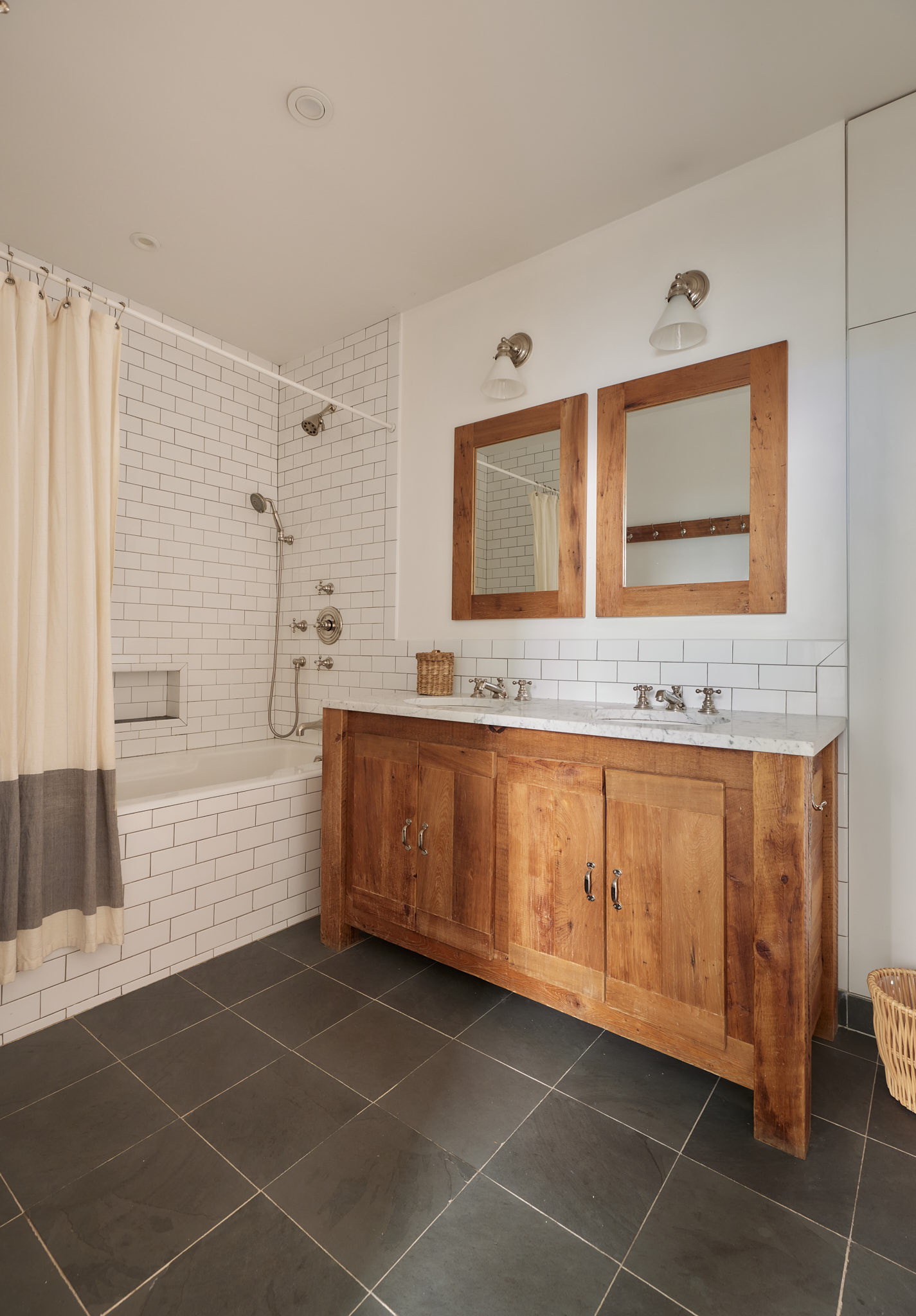 2 Bond Street, Unit 2 Manhattan, NY 10012 - Photo 12 of 16 a bathroom with a granite countertop sink a mirror and bathtub