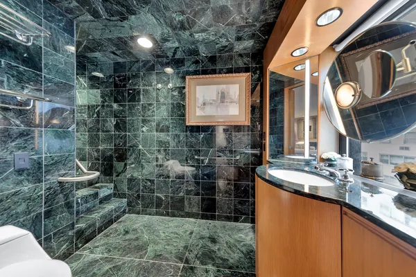 a bathroom with mirror sink and toilet