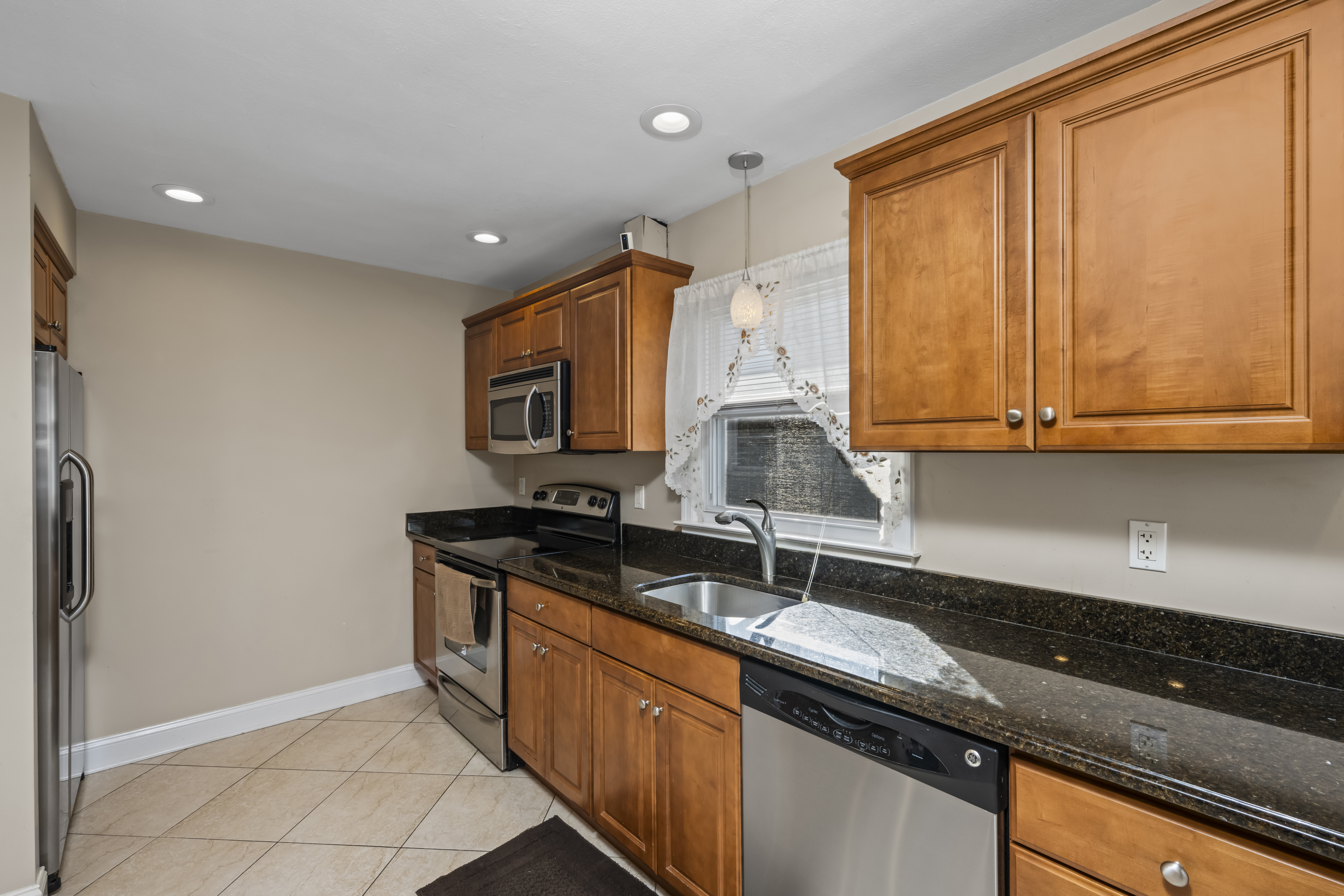 522 Stewart Avenue Staten Island, NY 10314 - Photo 9 of 33 a kitchen with stainless steel appliances granite countertop a sink a stove and a microwave