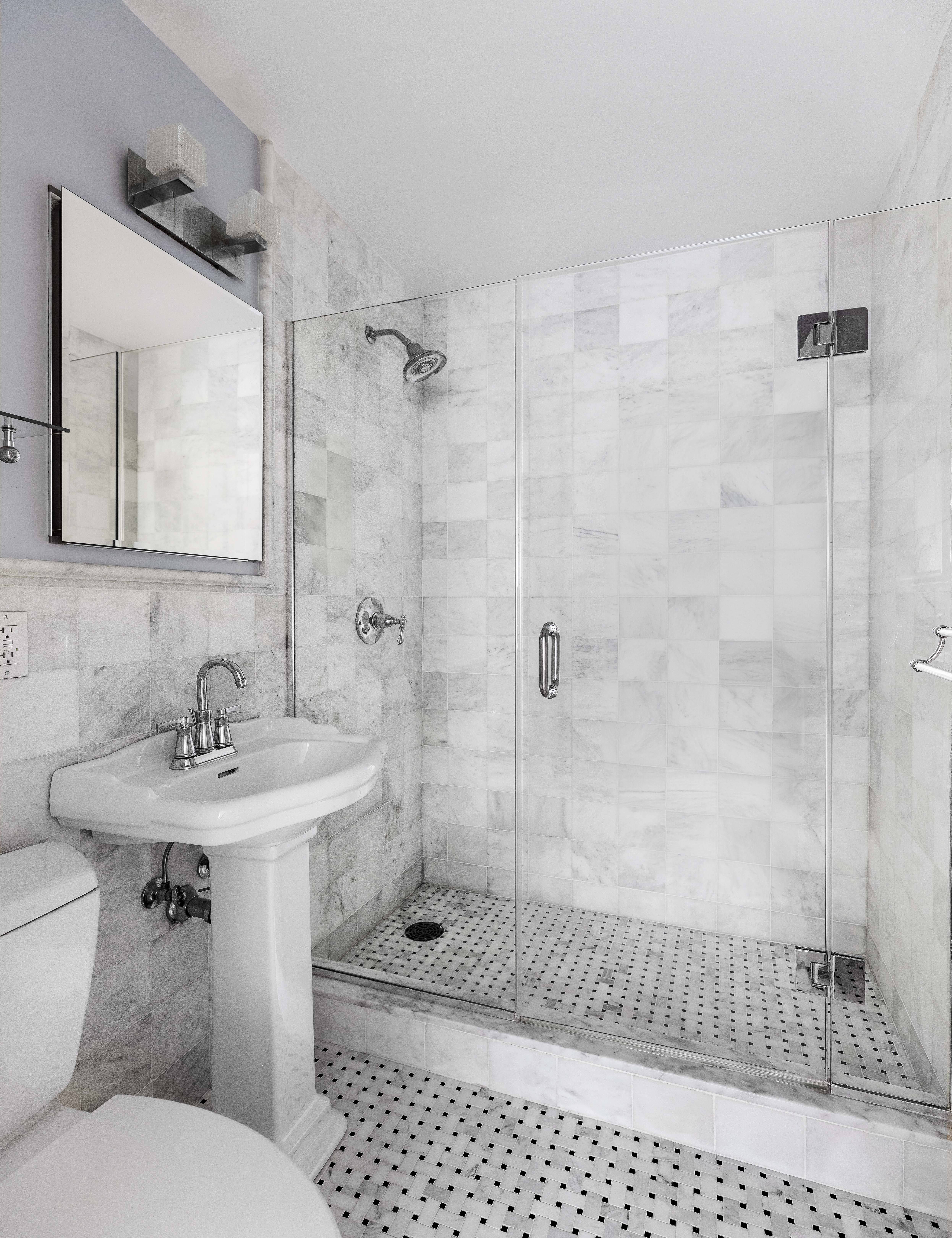 15 West 72nd Street, Unit 8TU Manhattan, NY 10023 - Photo 8 of 12 a bathroom with a sink toilet a mirror and shower