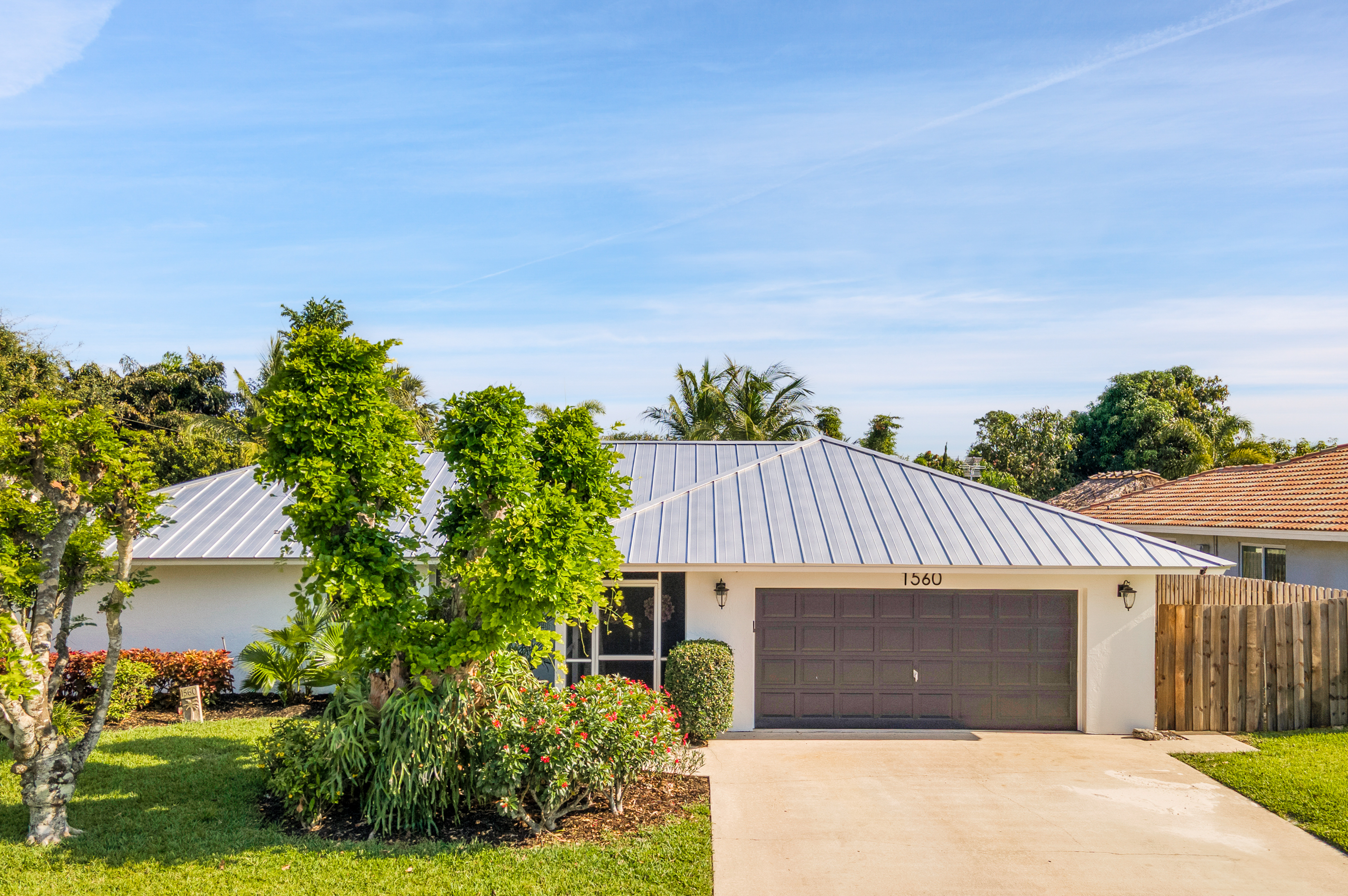 1560 Southwest 16th Street Boca Raton, FL 33486 - Photo 35 of 72 a front view of a house with a yard