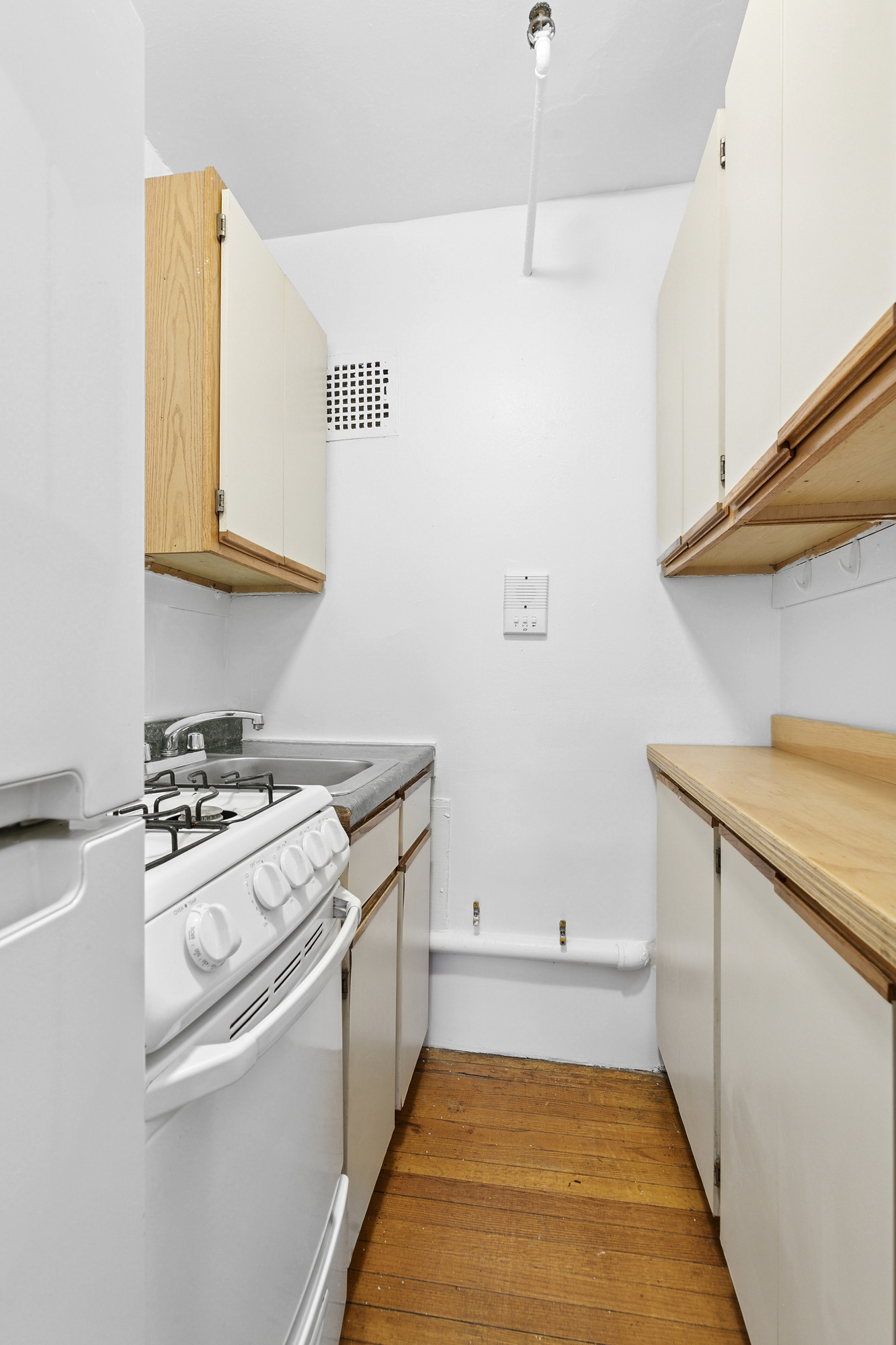 1100 Dean Street, Unit 3 Brooklyn, NY 11216 - Photo 3 of 5 a kitchen with a stove and a white cabinets