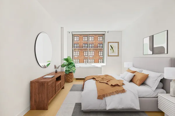 a bed sitting in a bedroom next to a window