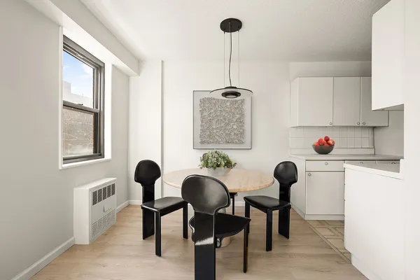 a dining room with furniture and window