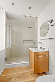 a bathroom with a tub sink mirror and vanity