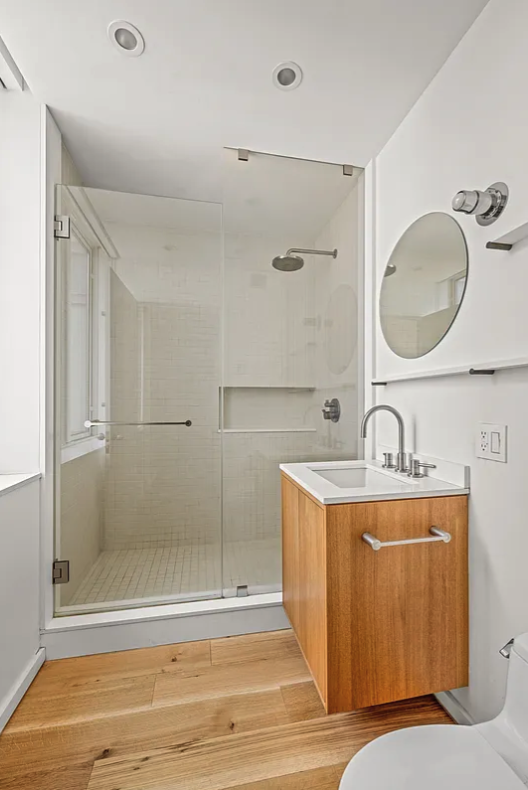 120 Riverside Boulevard, Unit 10W Manhattan, NY 10069 - Photo 8 of 13 a bathroom with a tub sink mirror and vanity