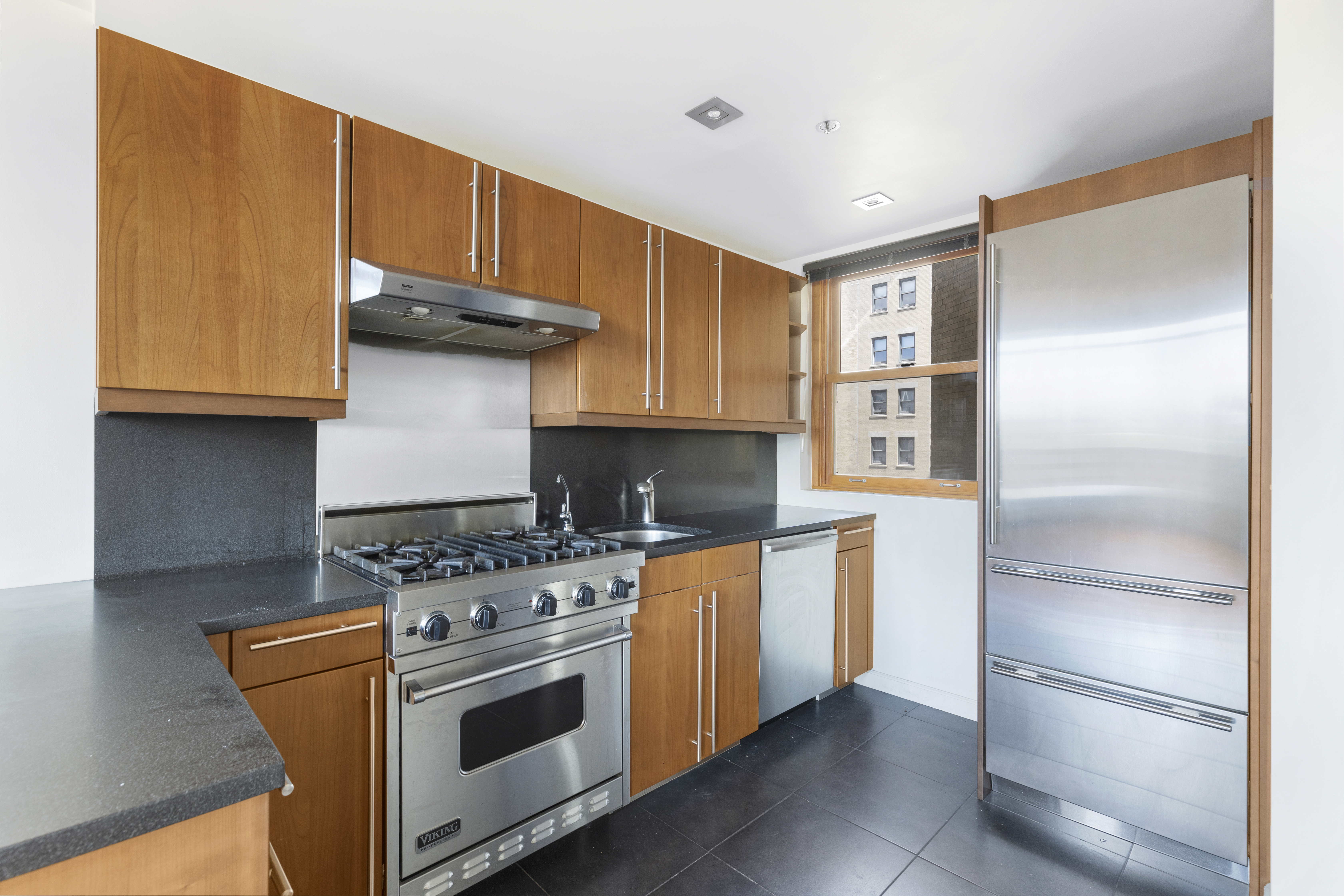 305 2nd Avenue, Unit 537 Manhattan, NY 10003 - Photo 5 of 11 a kitchen with stainless steel appliances granite countertop a refrigerator and a stove