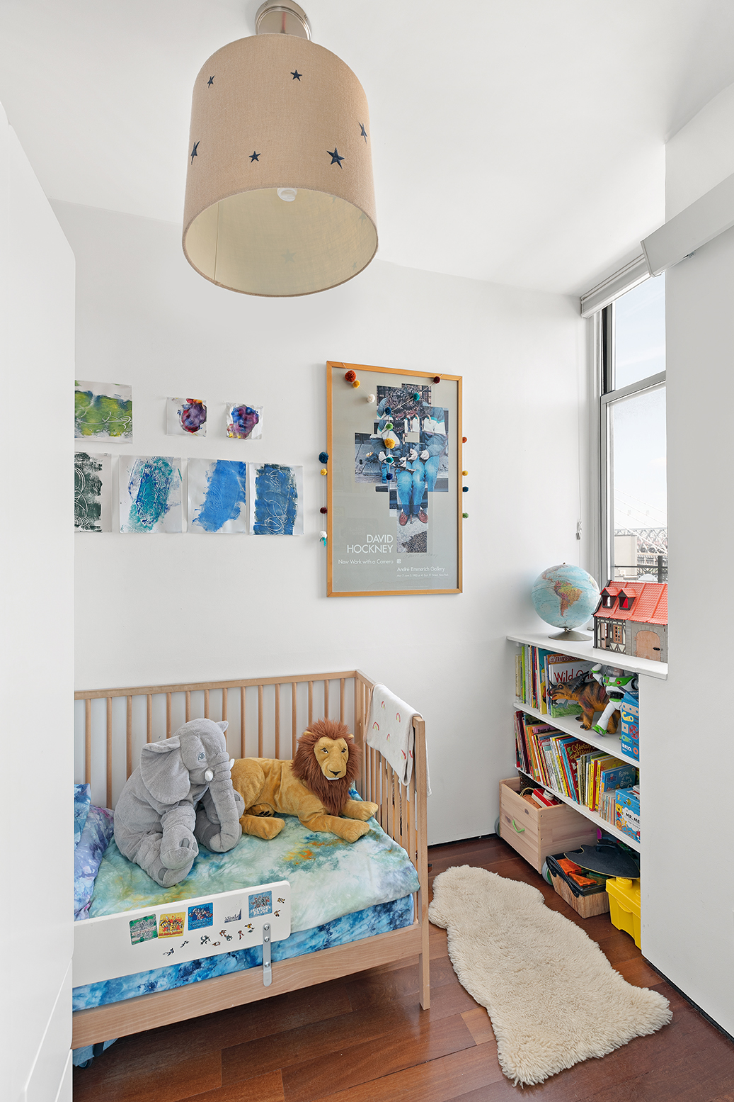 60 Broadway, Unit 6H Brooklyn, NY 11249 - Photo 9 of 16 a bedroom with furniture and a wooden floor