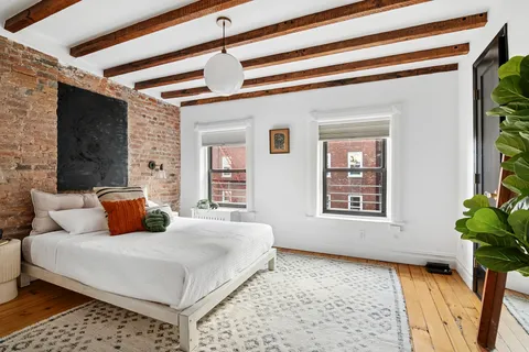 a bedroom with a large bed and a couch