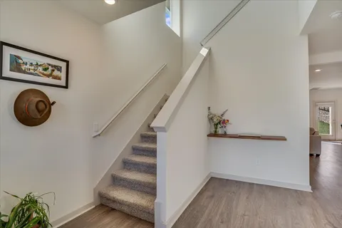 a view of staircase with wooden floor