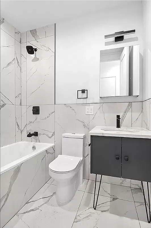 64 Granite Street, Unit 2 Brooklyn, NY 11207 - Photo 3 of 8 a bathroom with a sink toilet a mirror and shower