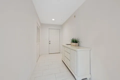 a hallway with white cabinets