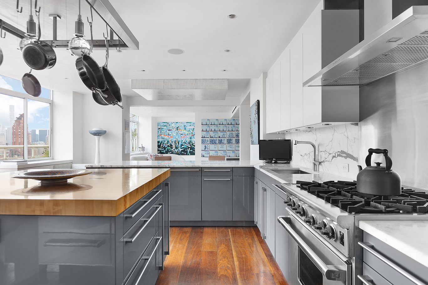 2373 Broadway, Unit PH1 Manhattan, NY 10024 - Photo 3 of 28 a kitchen with stainless steel appliances granite countertop a sink a stove and a wooden floors