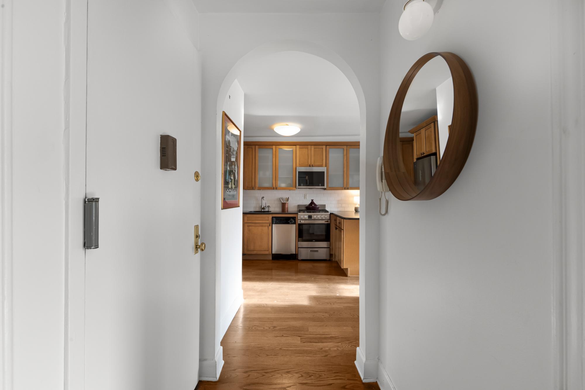 504 East 6th Street, Unit 5 Manhattan, NY 10009 - Photo 8 of 11 a view of a living room with furniture and a mirror