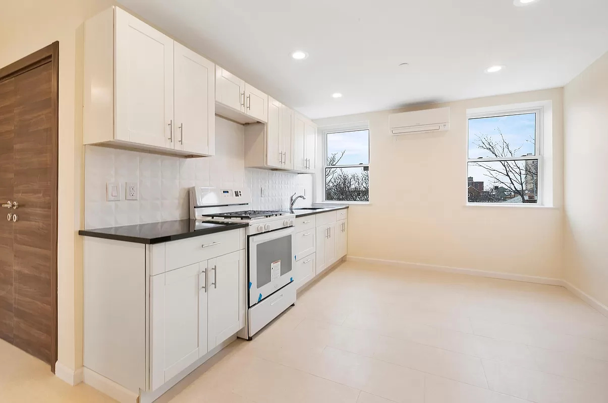 4015 Atlantic Avenue Brooklyn, NY 11224 - Photo 7 of 14 a kitchen with granite countertop white cabinets and white appliances