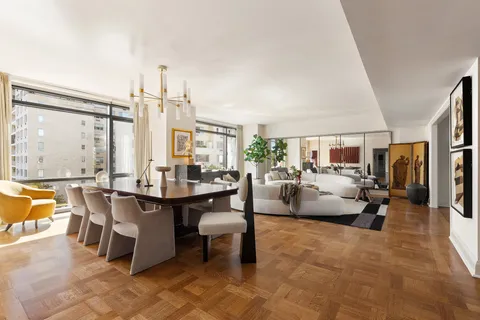 a living room with fireplace furniture and a large window