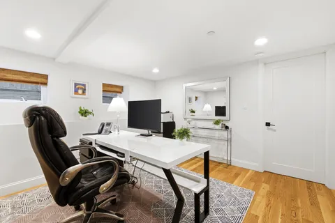 a view of a workspace with furniture and bathroom