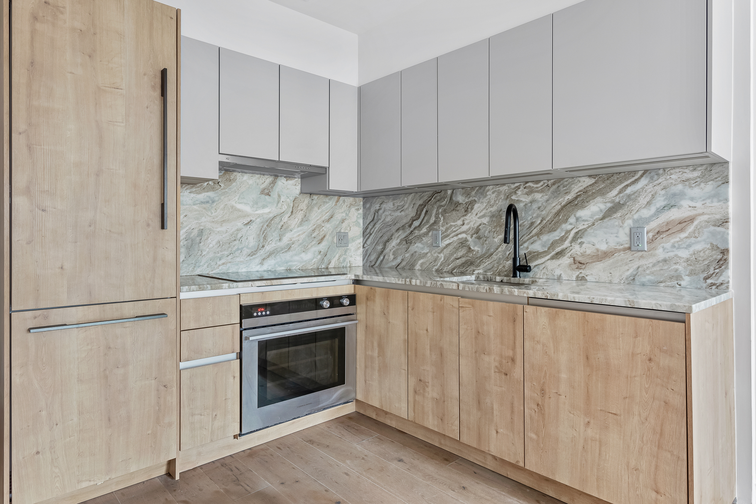 44 Box Street, Unit 2R Brooklyn, NY 11222 - Photo 4 of 9 a kitchen with granite countertop white cabinets and stainless steel appliances