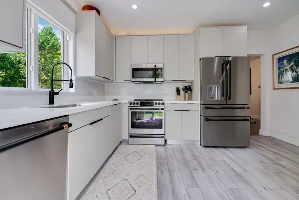 a kitchen with a refrigerator and a sink