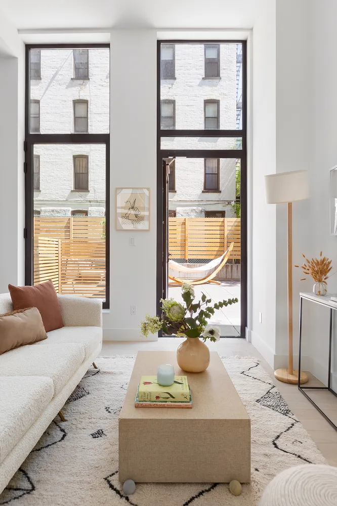 a living room with furniture and a floor to ceiling window