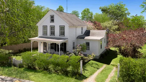 a front view of house with a garden