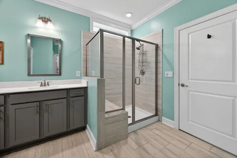 a bathroom with a double vanity sink mirror and shower