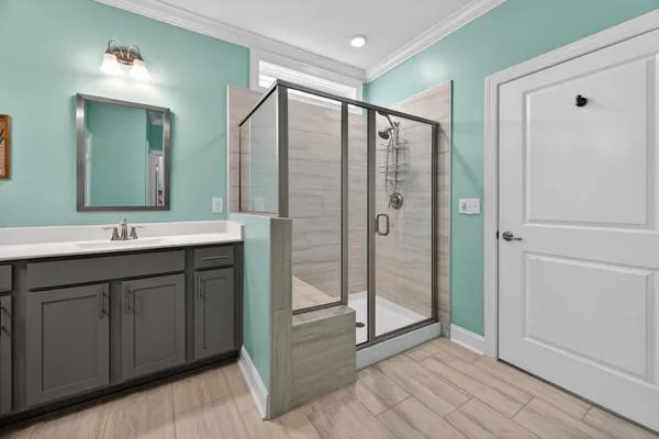 a bathroom with a double vanity sink mirror and shower