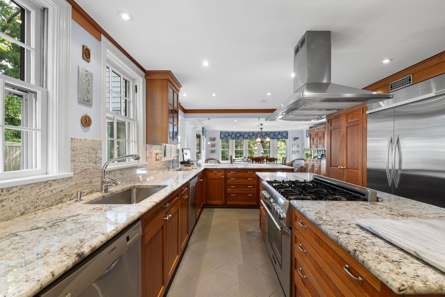 a kitchen with stainless steel appliances granite countertop a sink and stove