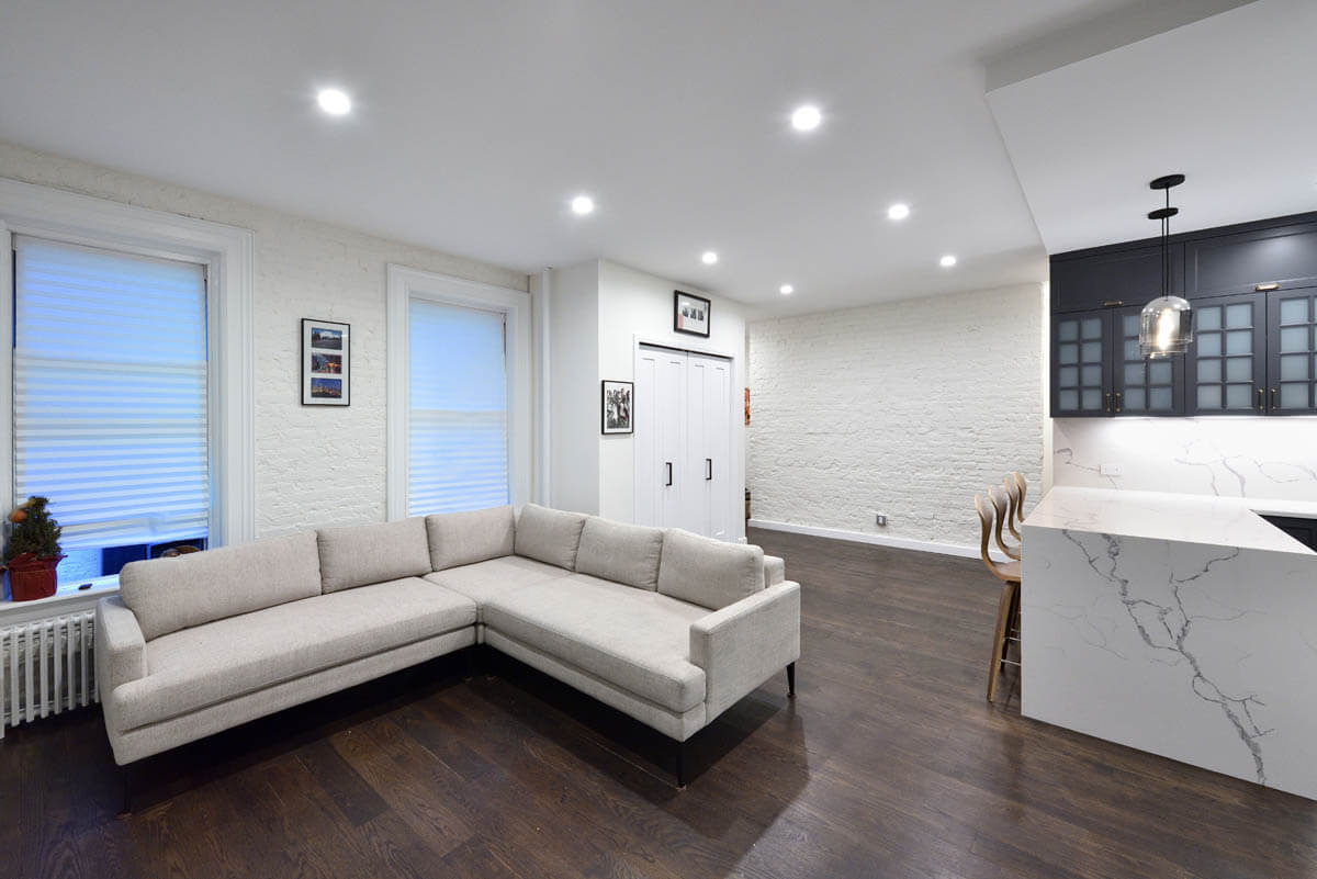 124 Thompson Street, Unit 11/12 Manhattan, NY 10012 - Photo 7 of 13 a living room with furniture and a wooden floor