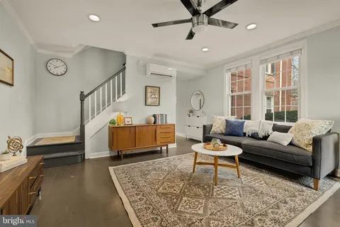 a living room with furniture and a rug