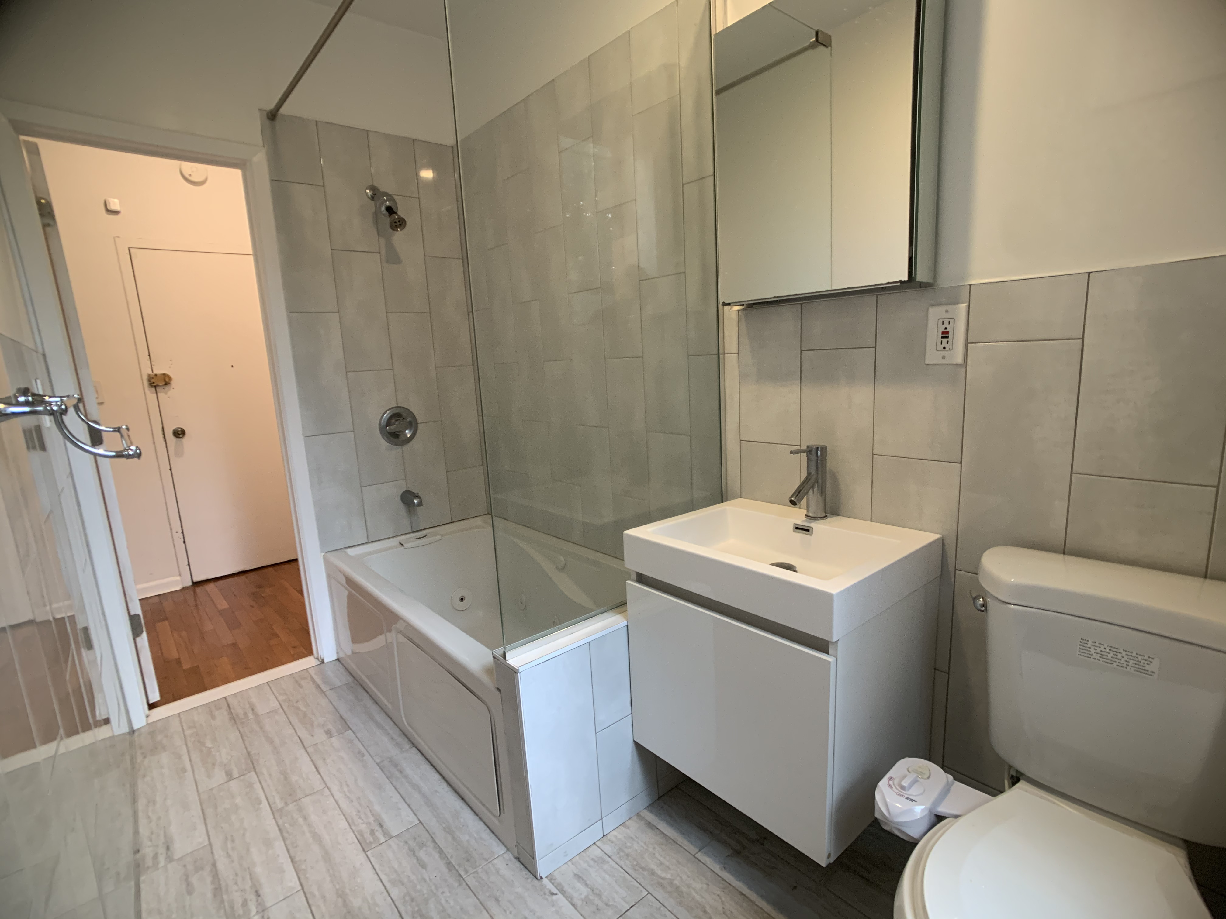 293 Tompkins Avenue Brooklyn, NY 11221 - Photo 14 of 19 a bathroom with a sink toilet and shower