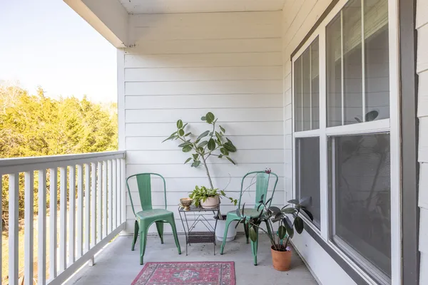 a dining room filled with furniture and a potted plant