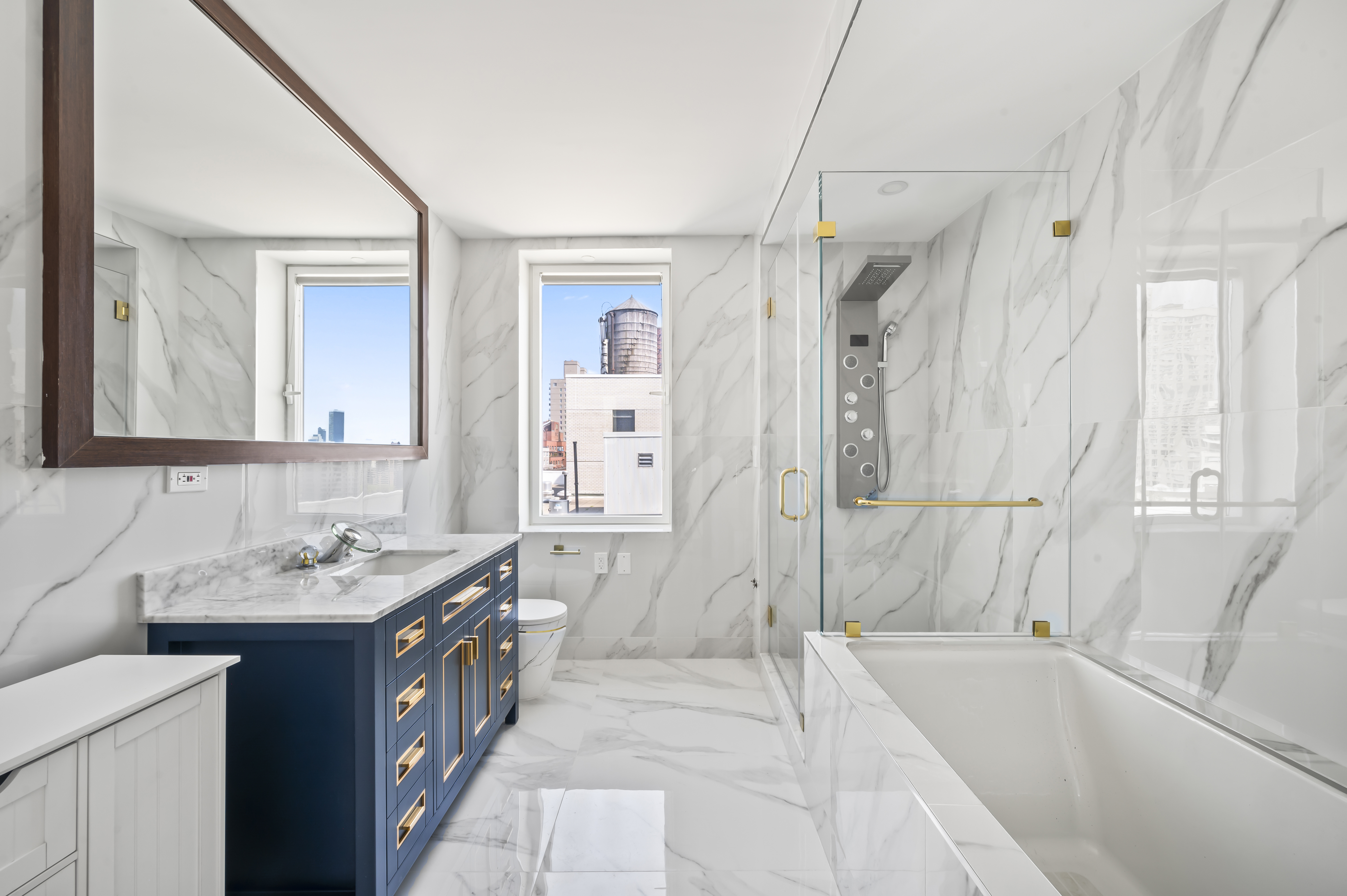 408 East 79th Street, Unit 16B Manhattan, NY 10075 - Photo 10 of 16 a bathroom with a tub sink and mirror