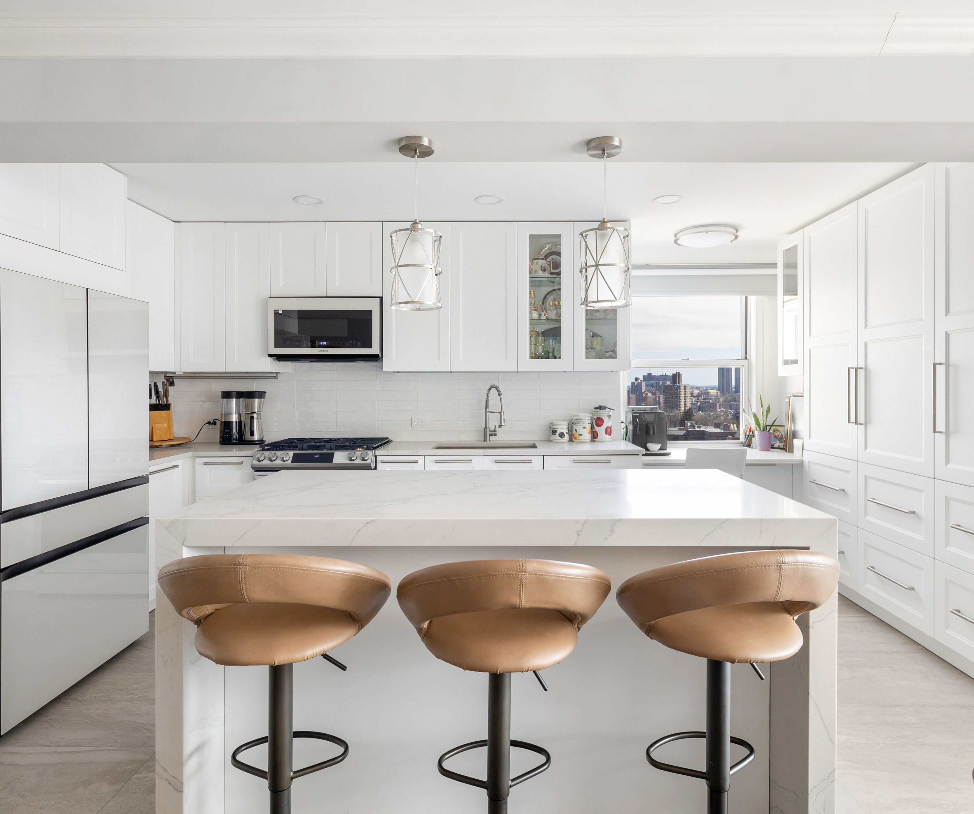 3755 Henry Hudson Parkway West, Unit PHA Bronx, NY 10463 - Photo 2 of 14 a kitchen with kitchen island granite countertop a sink cabinets and dining table