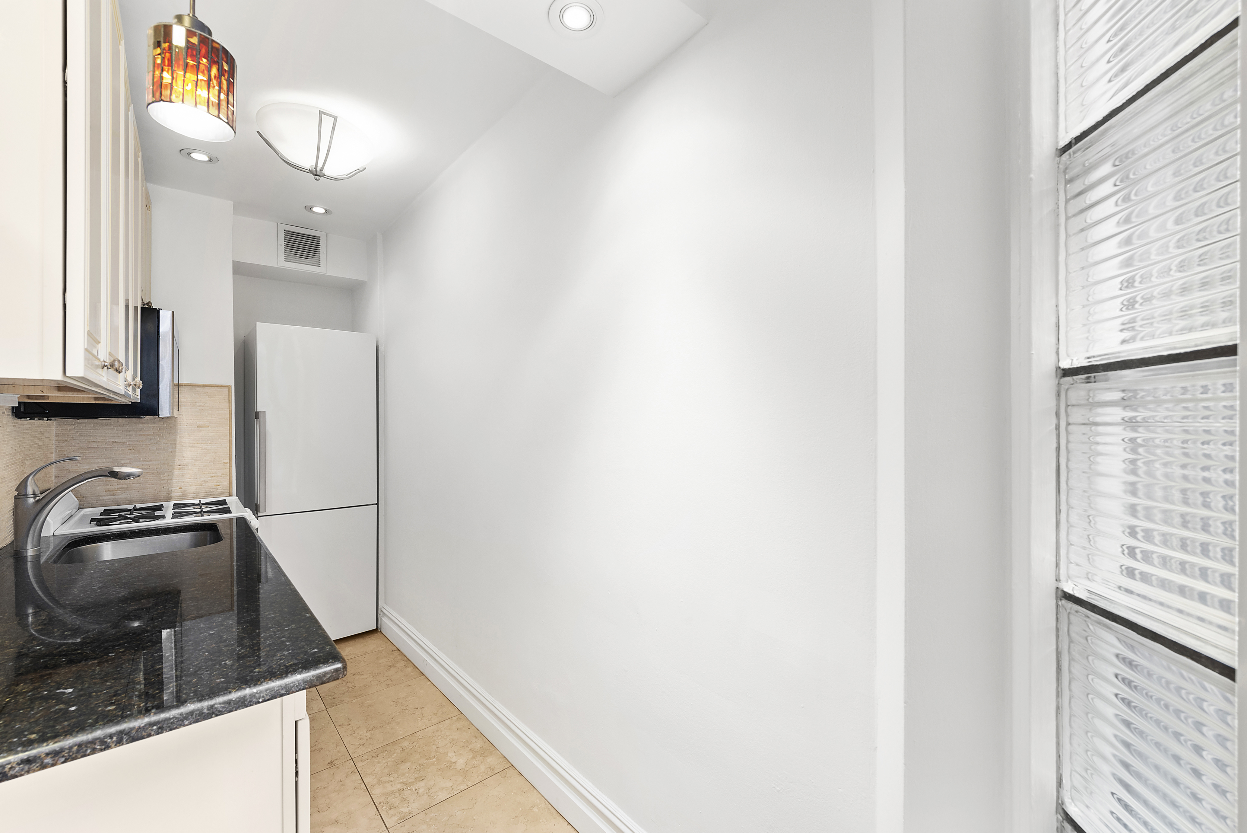 330 East 58th Street, Unit 5F Manhattan, NY 10022 - Photo 3 of 10 a bathroom with a sink and a window