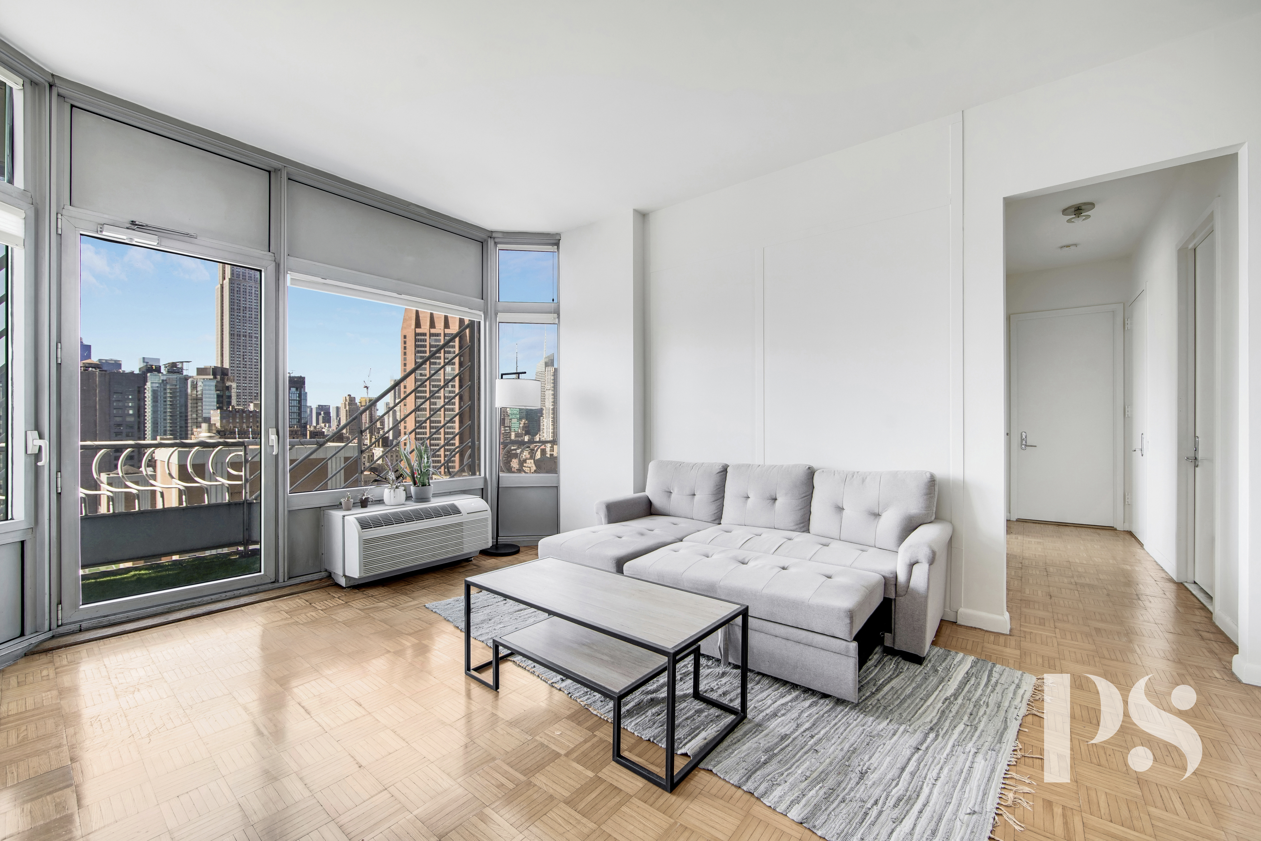200 East 32nd Street, Unit 33C Manhattan, NY 10016 - Photo 1 of 12 a living room with furniture and a table