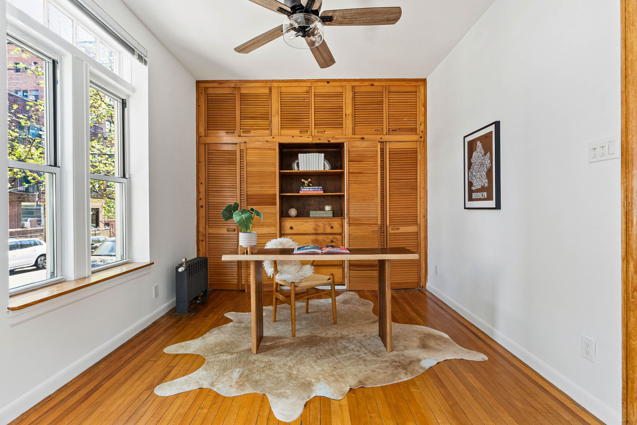 826 43rd Street, Unit 1 Brooklyn, NY 11232 - Photo 4 of 12 a work room with wooden floor and a window
