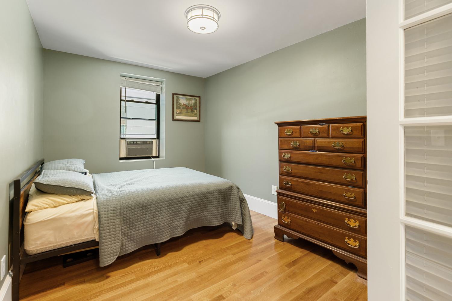 56 Prince Street Boston, MA 02113 - Photo 7 of 8 a bedroom with a bed and a window