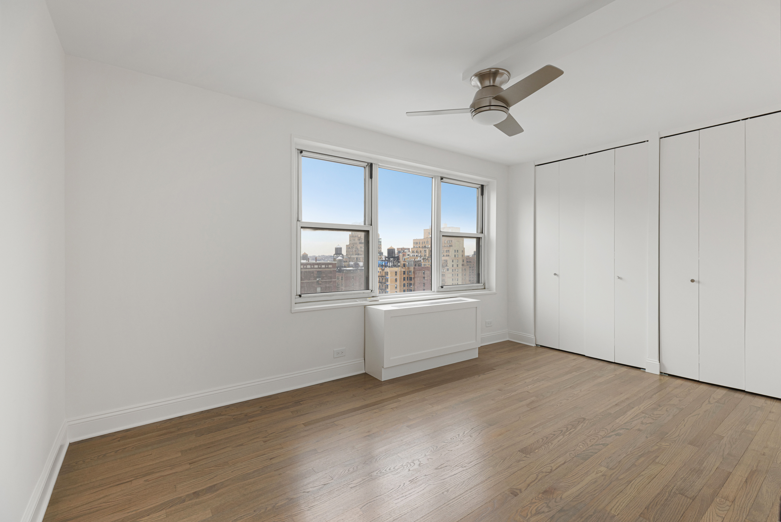 201 West 70th Street, Unit 20L Manhattan, NY 10023 - Photo 4 of 6 a view of an empty room with a window