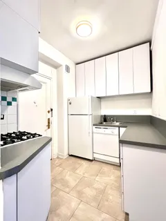 a kitchen with a stove a sink and a refrigerator
