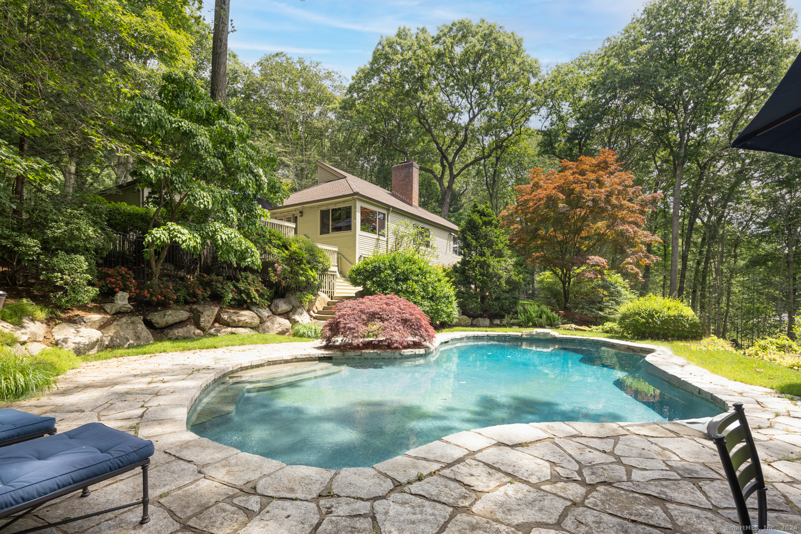 13 Bittersweet Road Weston, CT 06883 - Photo 26 of 35 a view of a swimming pool with a patio