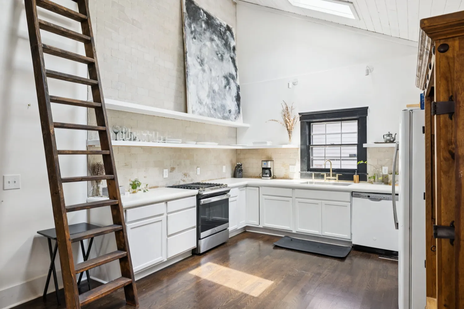 a kitchen with stainless steel appliances a stove and a window