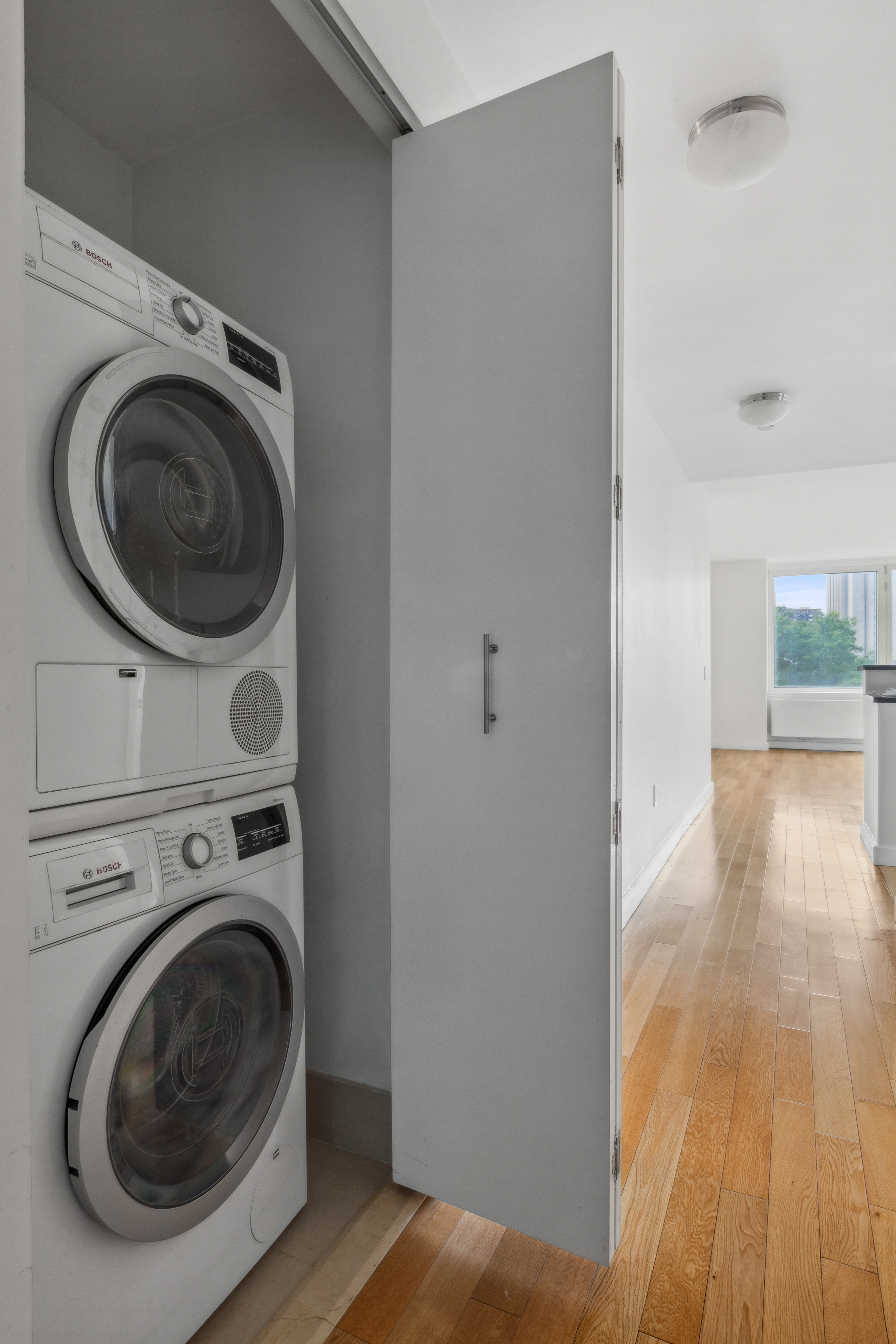 415 Main Street, Unit 4G Manhattan, NY 10044 - Photo 12 of 18 a view of washer and dryer in a utility room