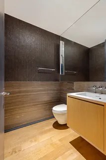 a bathroom with a sink a toilet and mirror